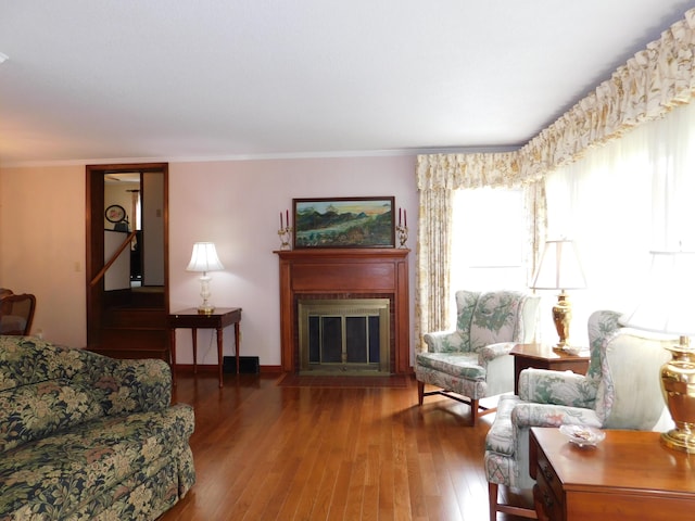 184 Meadow Dr, Harlan, KY 40831 - living area featuring hardwood / wood-style floors, a fireplace with flush hearth, and crown molding