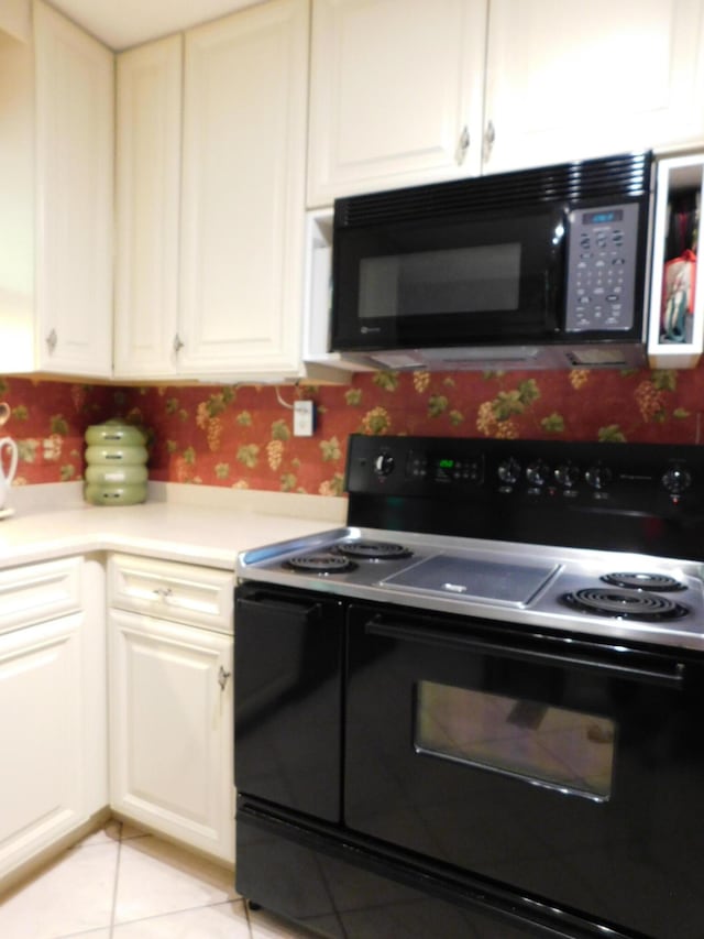184 Meadow Dr, Harlan, KY 40831 - kitchen featuring black appliances, light countertops, wallpapered walls, light tile patterned floors, and white cabinetry