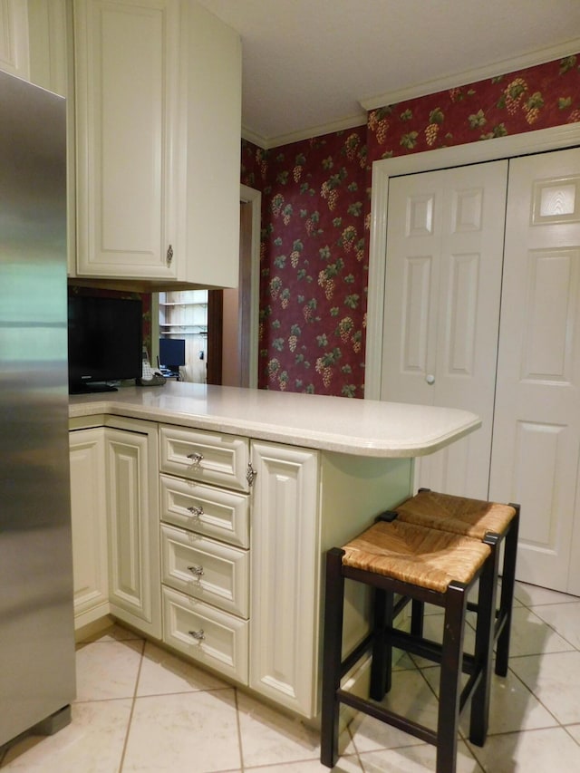 184 Meadow Dr, Harlan, KY 40831 - kitchen with freestanding refrigerator, light tile patterned floors, wallpapered walls, ornamental molding, and light countertops