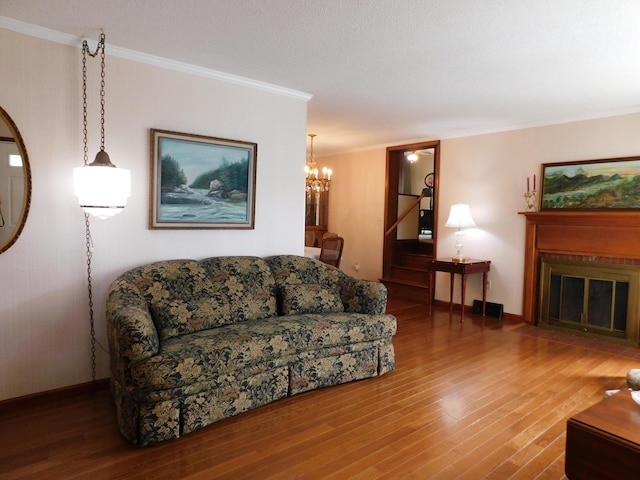 184 Meadow Dr, Harlan, KY 40831 - living area with wood finished floors, a chandelier, ornamental molding, a fireplace with flush hearth, and baseboards