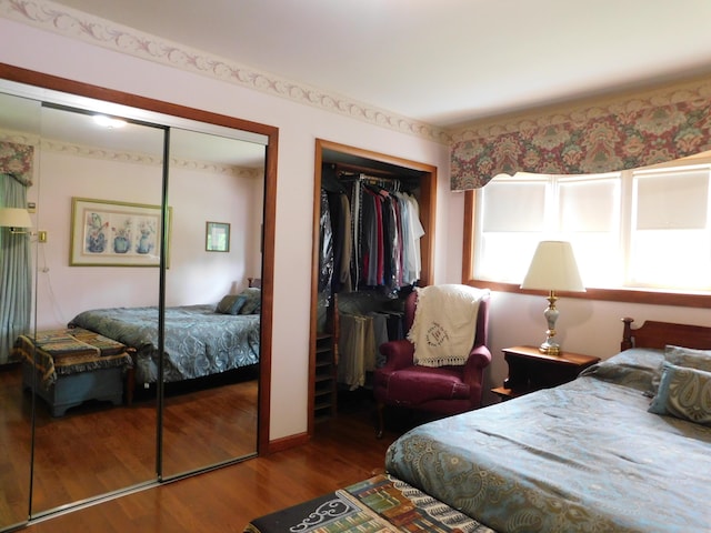 184 Meadow Dr, Harlan, KY 40831 - bedroom featuring two closets and wood finished floors