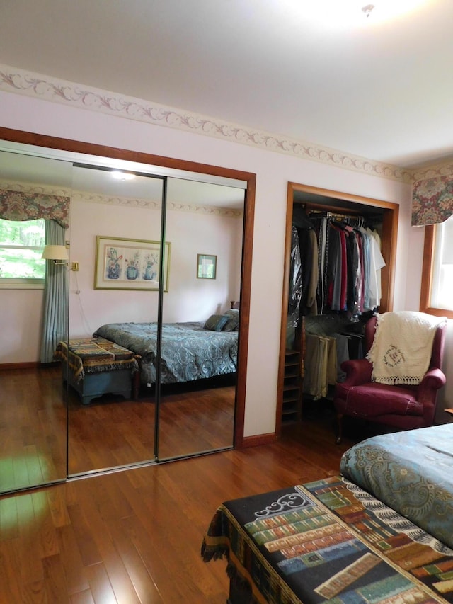 184 Meadow Dr, Harlan, KY 40831 - bedroom with multiple closets, wood finished floors, and baseboards