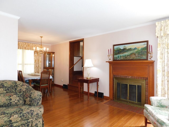 184 Meadow Dr, Harlan, KY 40831 - living area with a chandelier, wood finished floors, crown molding, a fireplace with flush hearth, and baseboards