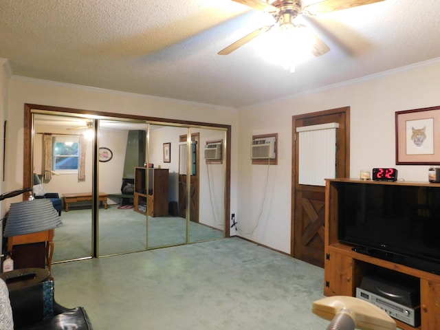 184 Meadow Dr, Harlan, KY 40831 - living area with a ceiling fan, carpet flooring, crown molding, a wall mounted AC, and a textured ceiling