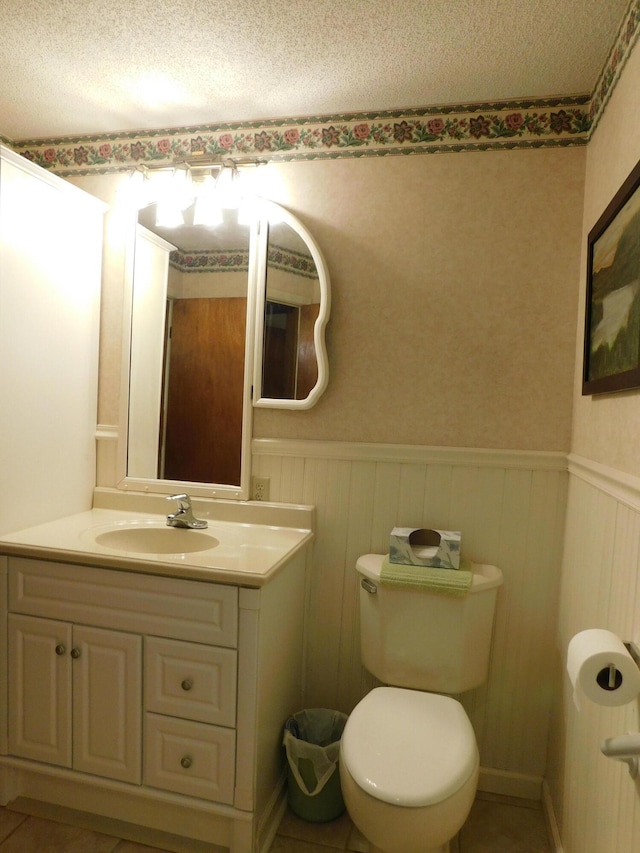 184 Meadow Dr, Harlan, KY 40831 - bathroom featuring wainscoting, vanity, toilet, and a textured ceiling