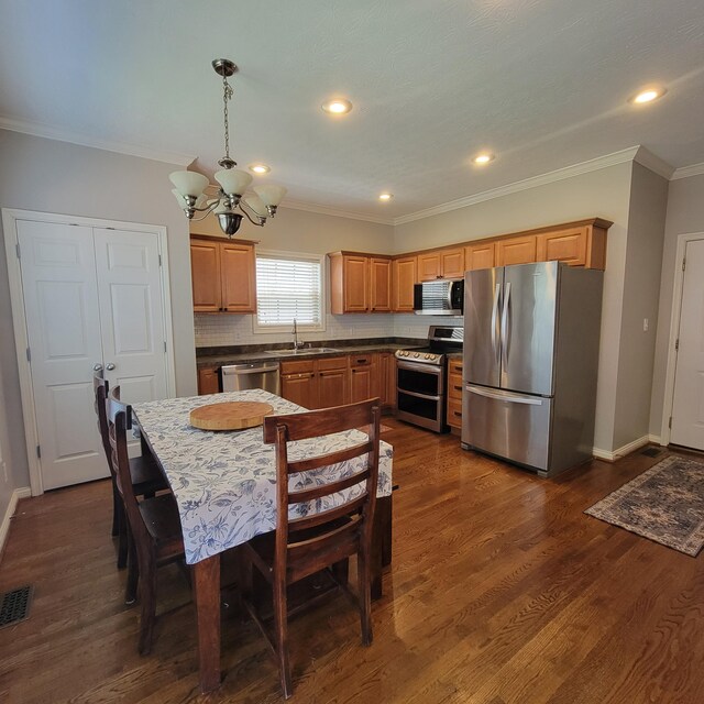 1136 Oatlands Park, Lexington, KY 40509 - kitchen with stainless steel appliances, a chandelier, a sink, decorative backsplash, and dark wood finished floors