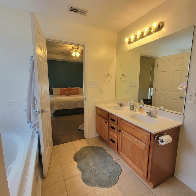 1136 Oatlands Park, Lexington, KY 40509 - ensuite bathroom with double vanity, tile patterned flooring, tiled bath, baseboards, and ceiling fan