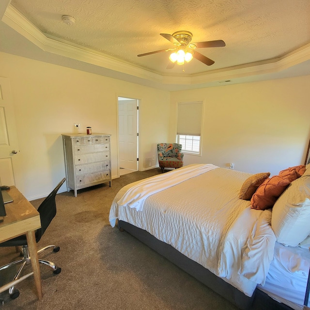 carpeted bedroom featuring a raised ceiling, ornamental molding, a ceiling fan, and baseboards