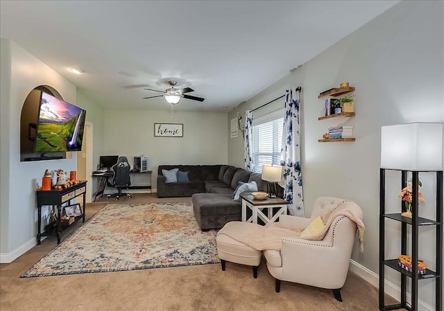 living area with carpet flooring, ceiling fan, an office area, and baseboards