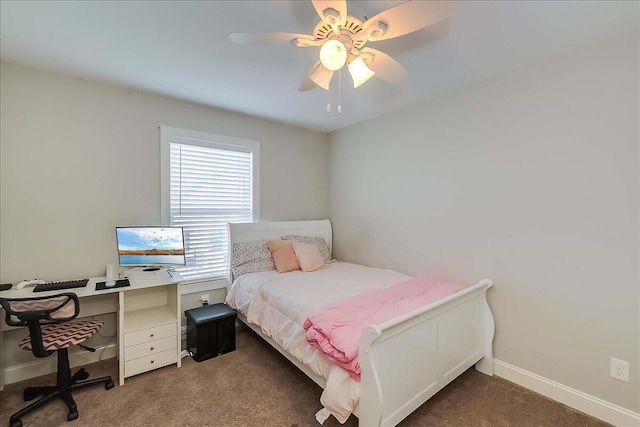 carpeted bedroom featuring baseboards, ceiling fan, and a desk
