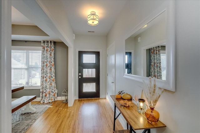 foyer featuring wood finished floors and baseboards