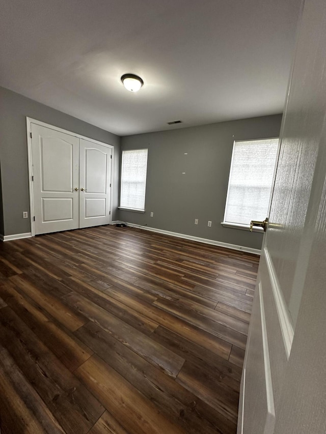1213 Seminole Trl, Georgetown, KY 40324 - unfurnished bedroom featuring dark wood finished floors, baseboards, and a closet