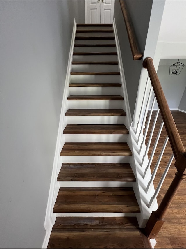 staircase featuring wood finished floors