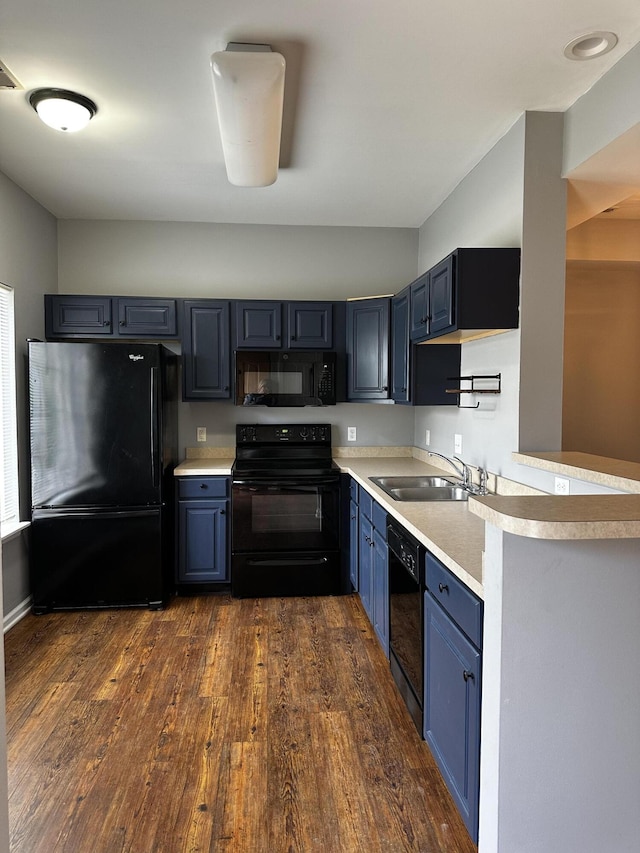 1213 Seminole Trl, Georgetown, KY 40324 - kitchen with black appliances, a sink, blue cabinetry, and light countertops