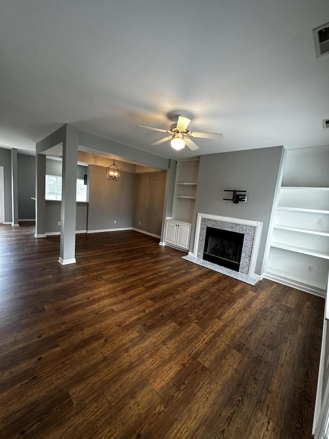 1213 Seminole Trl, Georgetown, KY 40324 - unfurnished living room with built in shelves, a ceiling fan, dark wood finished floors, a fireplace with flush hearth, and baseboards