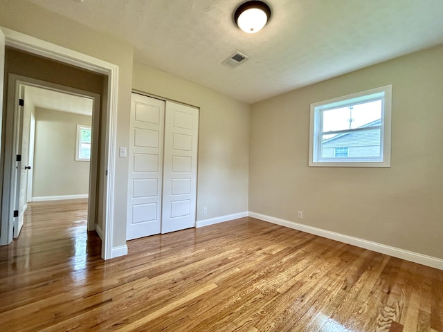 220 Jill Dr, Somerset, KY 42503 - unfurnished bedroom with multiple windows, wood finished floors, and baseboards