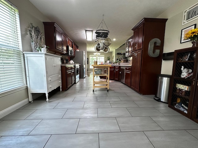76 Waterford Way, Somerset, KY 42501 - kitchen with appliances with stainless steel finishes, light countertops, a chandelier, and light tile patterned flooring