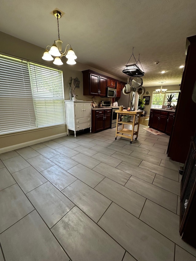 76 Waterford Way, Somerset, KY 42501 - kitchen featuring a chandelier, appliances with stainless steel finishes, pendant lighting, and dark brown cabinetry