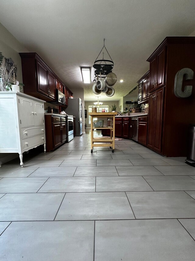 76 Waterford Way, Somerset, KY 42501 - kitchen featuring appliances with stainless steel finishes, a chandelier, and dark brown cabinets