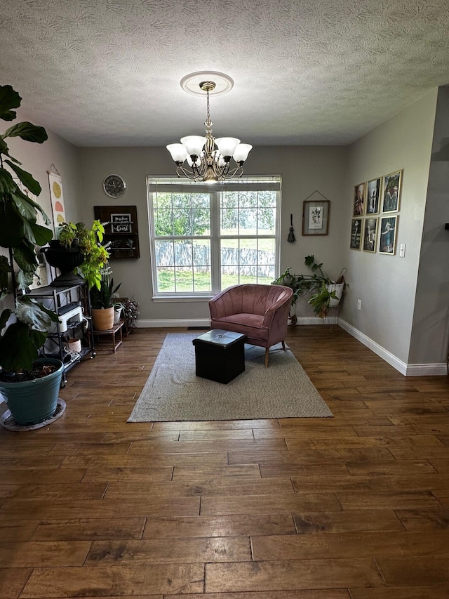 76 Waterford Way, Somerset, KY 42501 - living area with a chandelier, baseboards, dark wood finished floors, and a textured ceiling