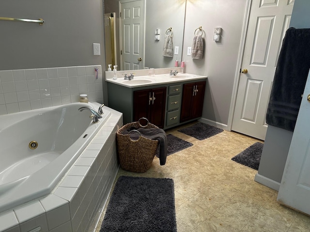 76 Waterford Way, Somerset, KY 42501 - bathroom featuring a tub with jets, double vanity, and baseboards