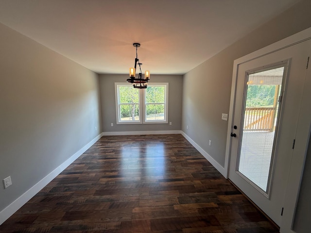 10 Nolan Dr, Corbin, KY 40701 - unfurnished dining area with a chandelier, dark wood-type flooring, and baseboards