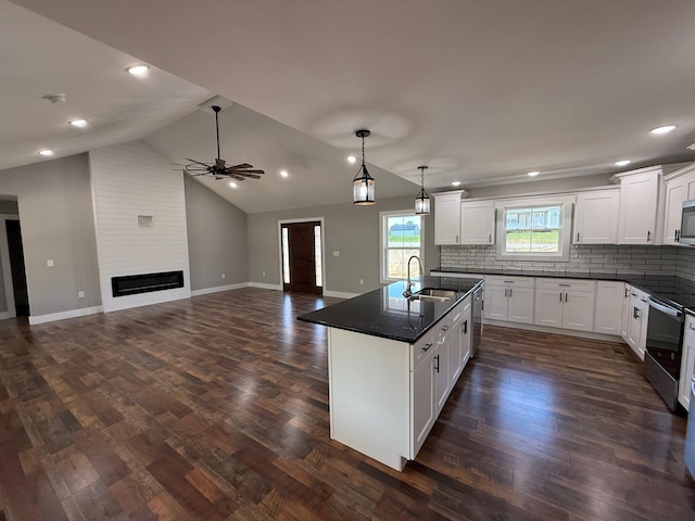10 Nolan Dr, Corbin, KY 40701 - kitchen with a sink, dark countertops, open floor plan, decorative backsplash, and ceiling fan