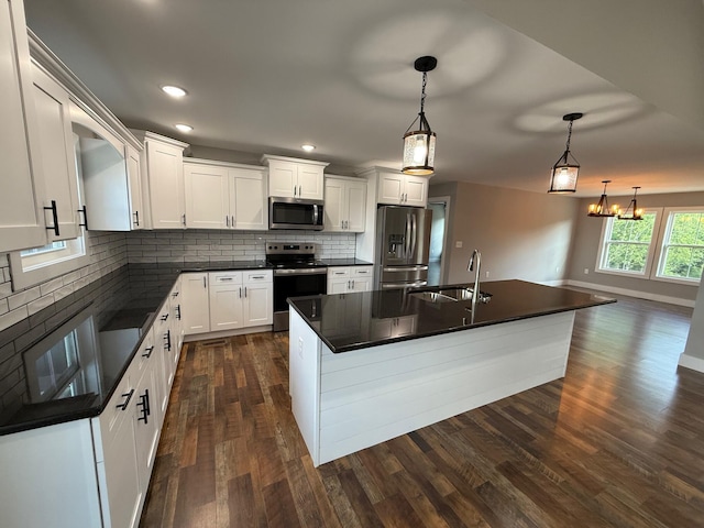 10 Nolan Dr, Corbin, KY 40701 - kitchen with appliances with stainless steel finishes, dark countertops, a sink, tasteful backsplash, and white cabinets