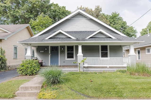1010 Aurora Ave, Lexington, KY 40502 - view of front of house featuring a porch, a shingled roof, and a front lawn