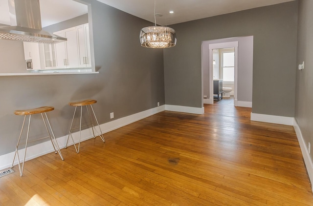 1010 Aurora Ave, Lexington, KY 40502 - unfurnished dining area with light wood-style floors, baseboards, a chandelier, and recessed lighting