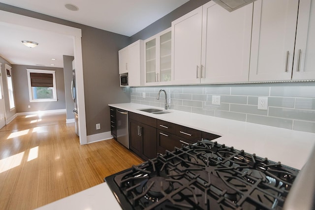 1010 Aurora Ave, Lexington, KY 40502 - kitchen with a sink, stainless steel appliances, light countertops, baseboards, and white cabinets