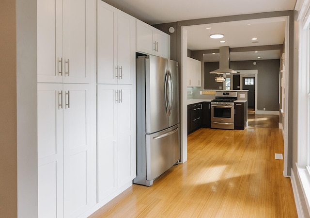 1010 Aurora Ave, Lexington, KY 40502 - kitchen with appliances with stainless steel finishes, ventilation hood, light wood-style flooring, light countertops, and white cabinets