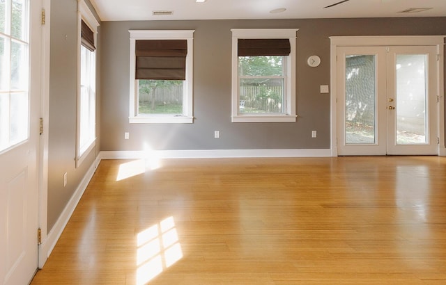 1010 Aurora Ave, Lexington, KY 40502 - spare room with light wood-style flooring, baseboards, and french doors