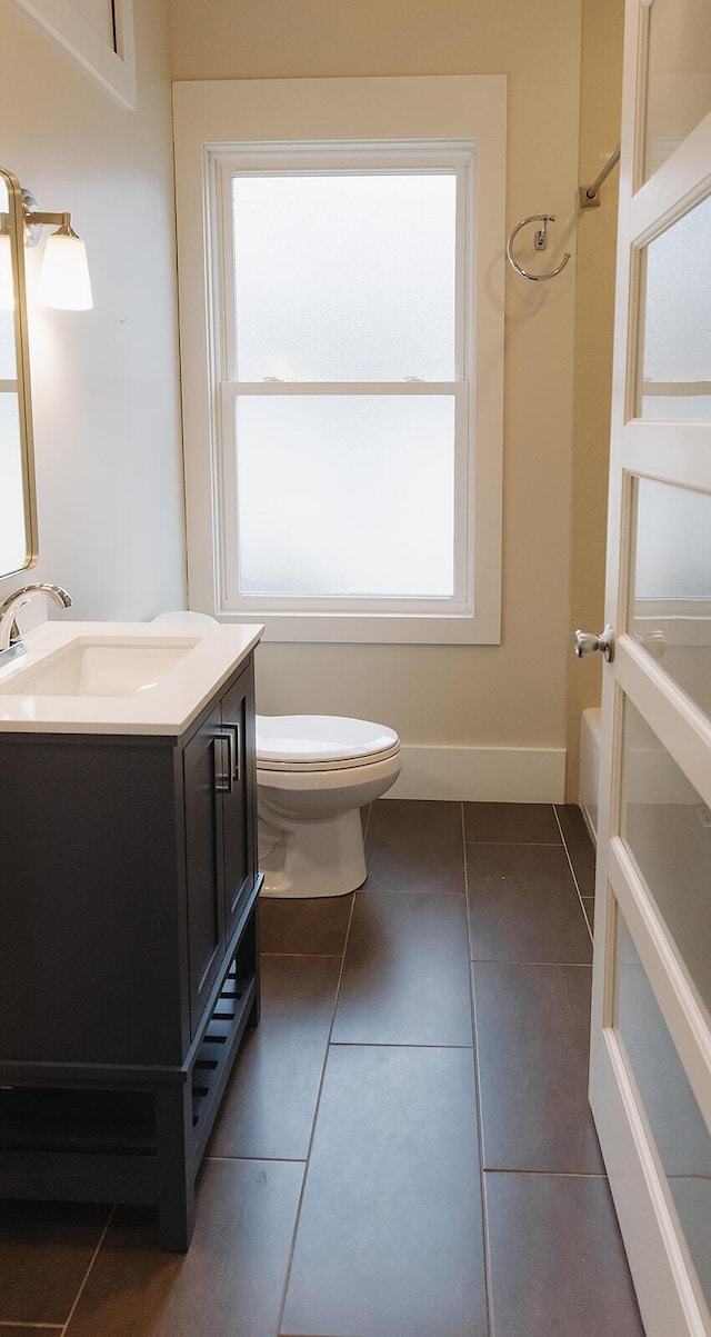 1010 Aurora Ave, Lexington, KY 40502 - bathroom with vanity, plenty of natural light, toilet, and tile patterned floors