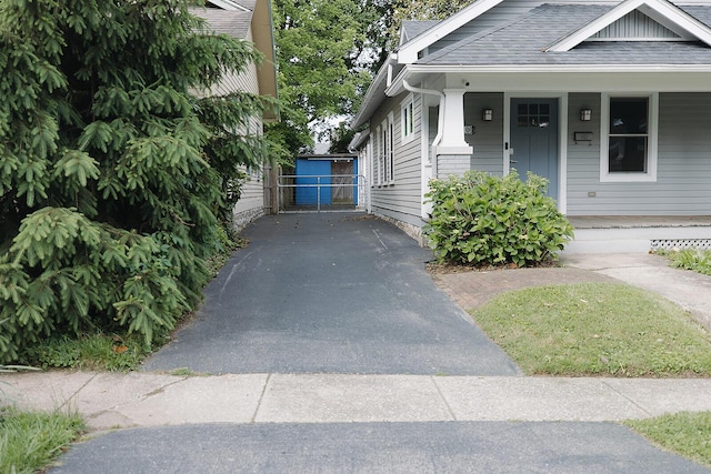 1010 Aurora Ave, Lexington, KY 40502 - view of front of property featuring covered porch, asphalt driveway, roof with shingles, and a gate