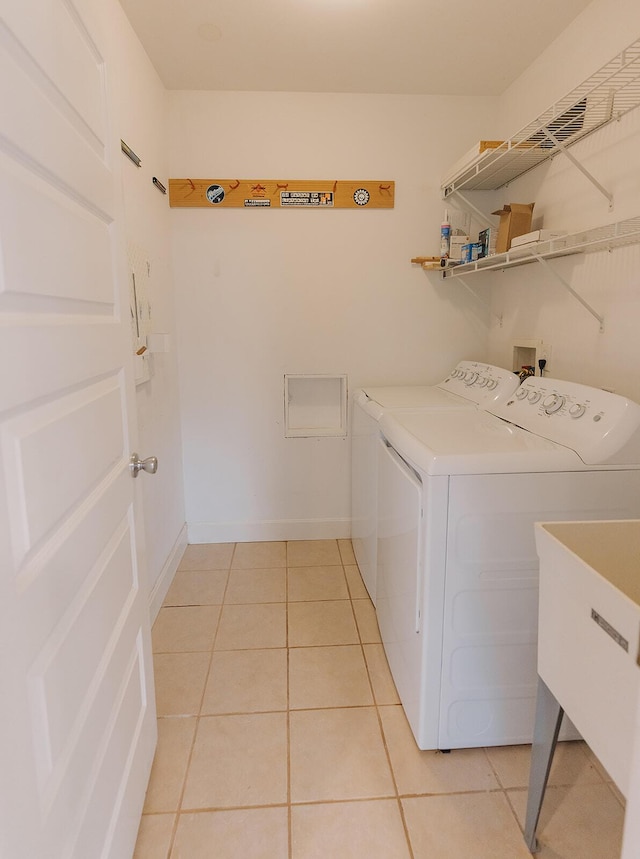 1010 Aurora Ave, Lexington, KY 40502 - washroom with washer and dryer and light tile patterned flooring