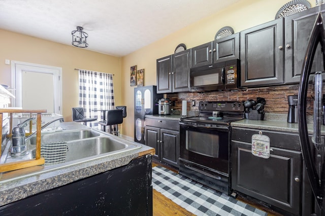 109 Rich Ln, Georgetown, KY 40324 - kitchen featuring black appliances, a sink, decorative backsplash, dark cabinetry, and light wood-type flooring