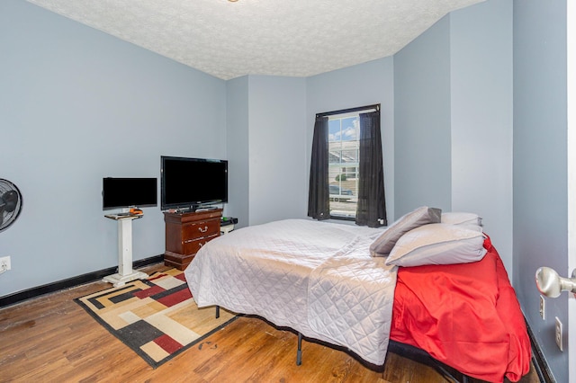 109 Rich Ln, Georgetown, KY 40324 - bedroom with wood finished floors, a textured ceiling, and baseboards