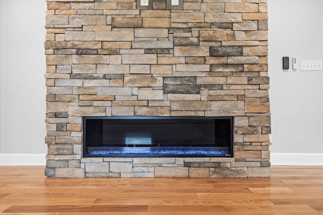 810 Cooper Dr, Lexington, KY 40502 - detailed view of a fireplace, baseboards, and wood finished floors