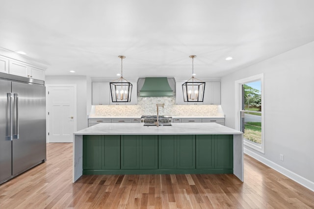 810 Cooper Dr, Lexington, KY 40502 - kitchen featuring built in refrigerator, premium range hood, white cabinets, decorative backsplash, and light wood-style floors