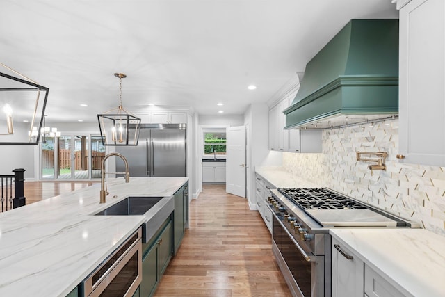 810 Cooper Dr, Lexington, KY 40502 - kitchen with built in appliances, custom exhaust hood, a sink, plenty of natural light, and recessed lighting