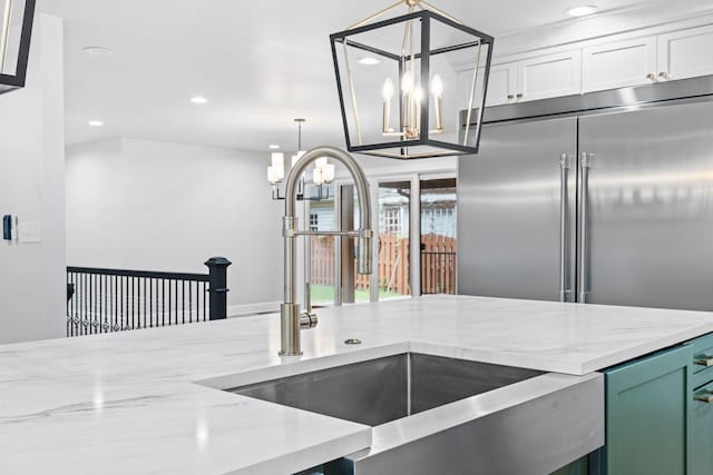 810 Cooper Dr, Lexington, KY 40502 - kitchen featuring a chandelier, stainless steel built in refrigerator, a sink, recessed lighting, and light stone counters