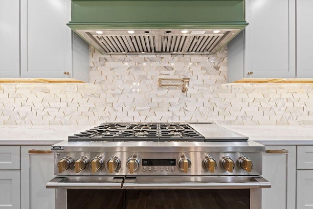 810 Cooper Dr, Lexington, KY 40502 - kitchen with high end stove, light countertops, custom exhaust hood, and decorative backsplash