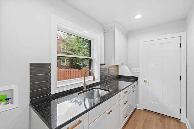810 Cooper Dr, Lexington, KY 40502 - kitchen with a sink, white cabinetry, dark stone counters, light wood-type flooring, and recessed lighting