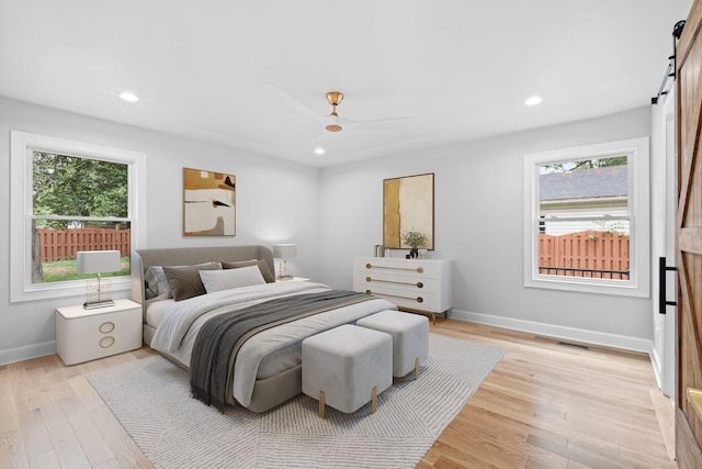 810 Cooper Dr, Lexington, KY 40502 - bedroom featuring a barn door, light wood finished floors, baseboards, and recessed lighting