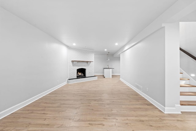 810 Cooper Dr, Lexington, KY 40502 - unfurnished living room with recessed lighting, stairway, light wood-style flooring, a fireplace, and baseboards
