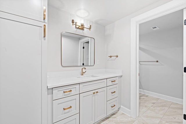 810 Cooper Dr, Lexington, KY 40502 - bathroom with marble look tile flooring, vanity, and baseboards