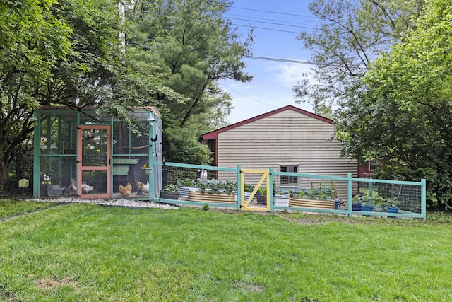 3488 Elmendorf Way, Lexington, KY 40517 - view of grassy yard featuring a vegetable garden, exterior structure, and an outbuilding
