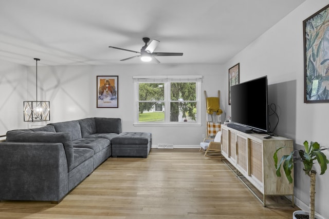 3488 Elmendorf Way, Lexington, KY 40517 - living room with light wood-style floors, a chandelier, a ceiling fan, and baseboards
