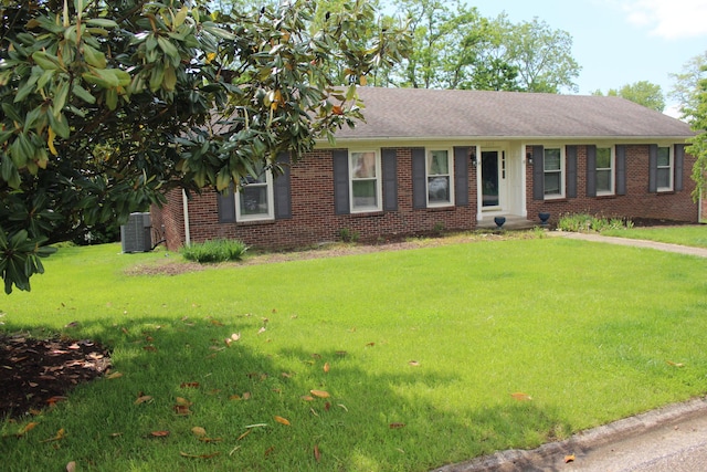 ranch-style house featuring brick siding, central AC unit, a front lawn, and a shingled roof